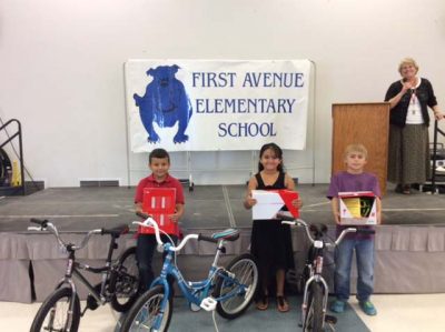 At First Avenue Elementary, students receiving bicycles are, from left, Noah Salaiz (first grade), Carla Flores (second) and Joseph White (third).