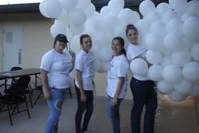 Members of the FCCLA get the balloons ready for the balloon ceremony.