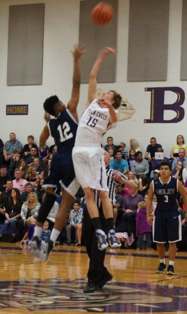 Queen Creek's Kade Parks (15) battles for the opening tip in Thursday's game.
