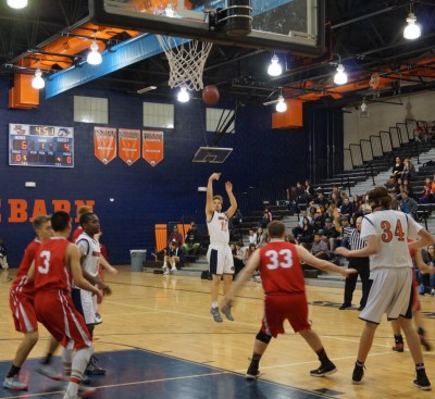Poston Butte forward Josh Zaker fires an open three during the first quarter of the Broncos' 65 - 37 victory. 