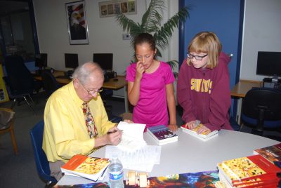 D.A. Lee signs autographs for students.