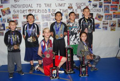 The wrestling Cougars are, from left, (back) DJ Small, Jacob Tafoya, GilbertRodriguez, Miles Smith and Victor Fittz, (front) Charles Croci and Sophia Smith.