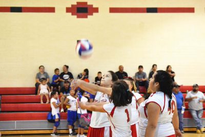 Mireya Curry bumps the ball over the net while her teammates stand by ready to assist. Photo by Araceli Curry, SMHS