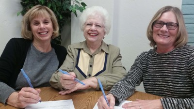 Rachel Opinsky, Elaine Helzer and Mary Huebner  sign the closing documents for the Oracle Piano Society's Oracle Center for the Arts.