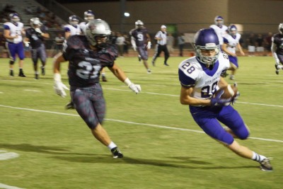 Queen Creek's Trexton Bloom runs after the catch against Hamilton last Friday night.
