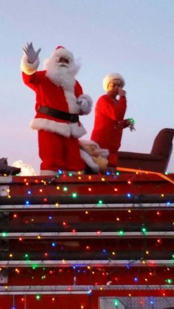 Santa and Mrs. Claus on Santa's Sleigh-for-the-day,  a Superior Fire Truck
