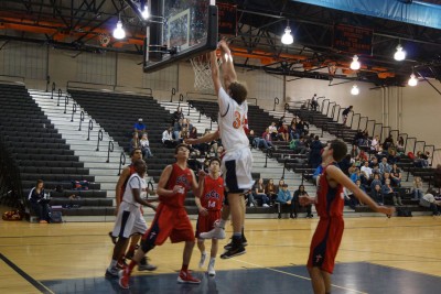 Tyson Berringer (34) puts down a dunk over a SCA defender.