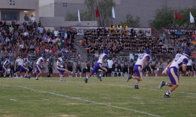 Zach Glaess (21) boots the opening kickoff against Desert Mountain.