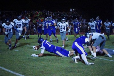 Zane Whiting (17) falls forward after a reception against Higley.