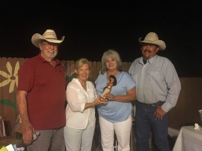 Sonny Sansom and Leslie Martin pass on the famed Copper Gecko statue to Rosemary and Argel Quiroz at the Copper Gecko Retirement Celebration hosted by Pat Richards on Saturday.  