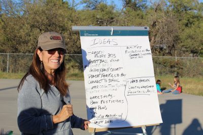 Volunteer Alicia Bristow writes ideas for the community garden in Oracle Arizona.