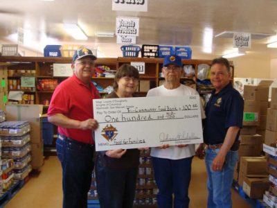 Knights of Columbus make a donation to the local food bank.