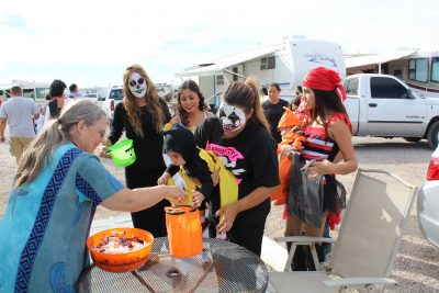 Diane Hernandez, Oracle resident and Rocky Point visitor, hands candy out to trick-or-treaters.